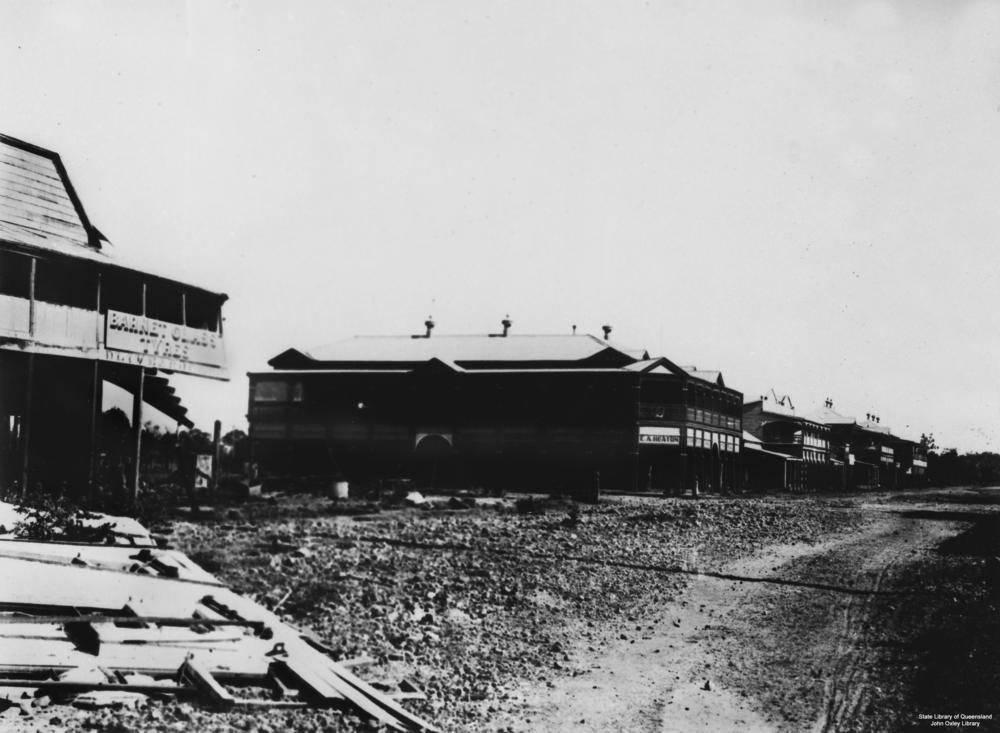 Street scene in Clermont after the flood in 1916 had subsided. Debris and remains of wooden shop fronts are displayed.'John Oxley Library, State Library of Queensland Image: 4113'.