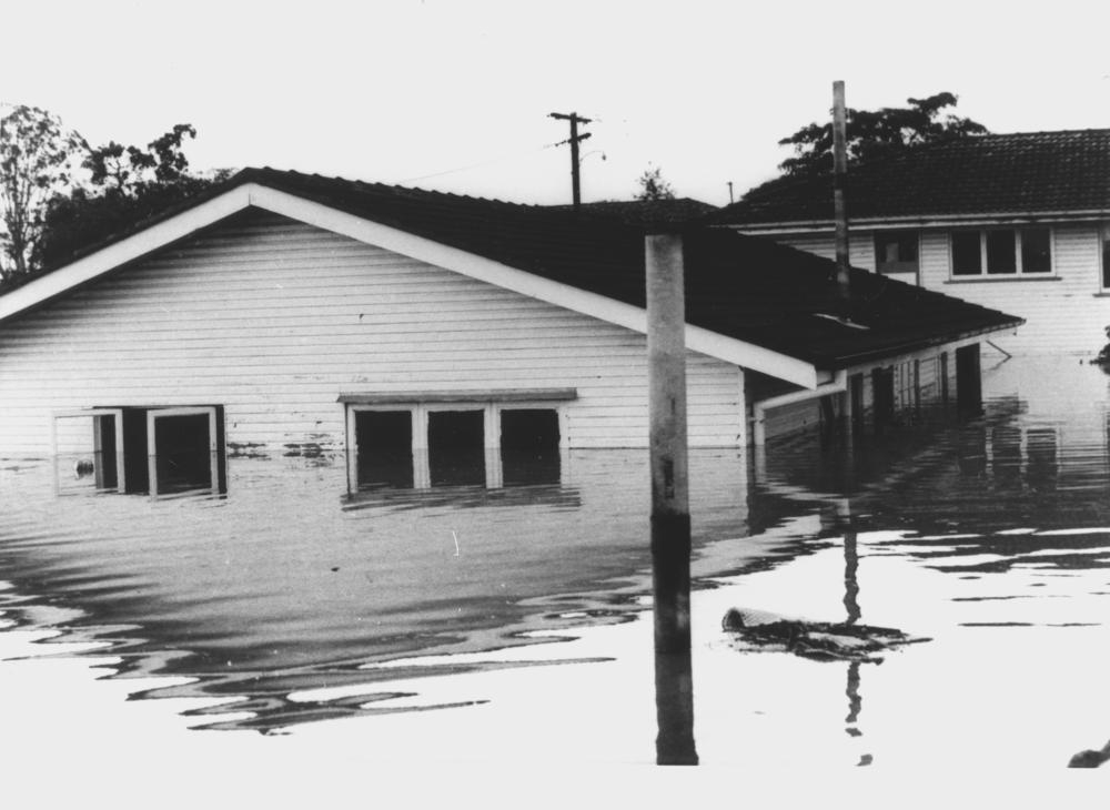 Submerged house at Oxley during the 1974 Brisbane Flood , 'John Oxley Library, State Library of Queensland Image: 180283'.