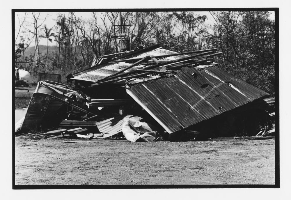 Building wrecked during Cyclone Larry, Bruce Highway near Innisfail, April 2006 , 'John Oxley Library, State Library of Queensland Image: 6462-0001-0002'.