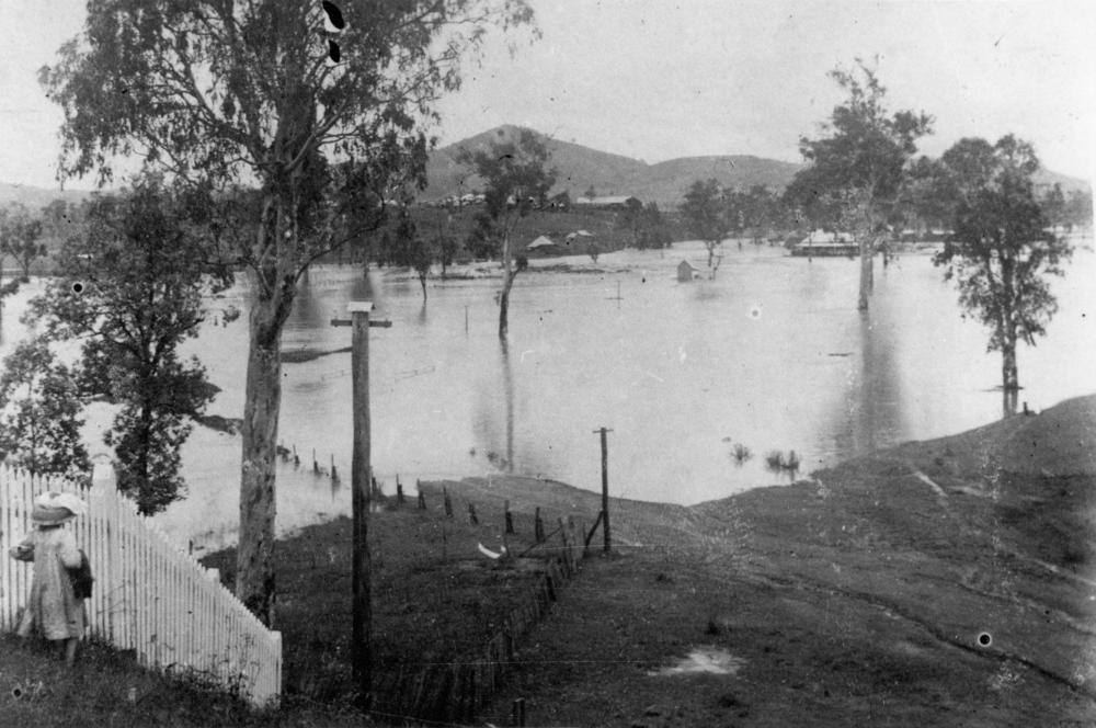 An unidentified girl is watching the flood waters at Dugandan flats. 'John Oxley Library, State Library of Queensland image: 280751'