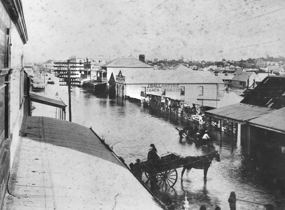 View along Stanley Street from the intersection with Melbourne Street during the 1887 Brisbane floods. Water is lapping up the sides of buildings including J. Ballantyne Coach Builder and the Sydney Meat Market. People are been transported by row boats or horse and buggy across or along the street. 'John Oxley Library, State Library of Queensland,  Image: 66443'.

