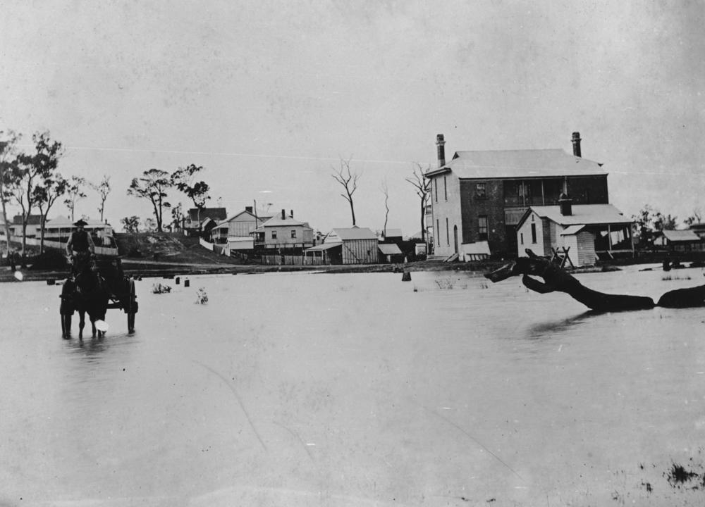 Floodwaters at the back of Sandgate Post Office in 1887. 'John Oxley Library, State Library of Queensland Image: 36250'.