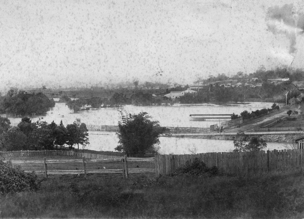 View over the corner of Bowen Bridge Road and Campbell Streets, Bowen Hills, with the Albert Sports Ground under water.  'John Oxley Library, State Library of Queensland   Image: 204034'.