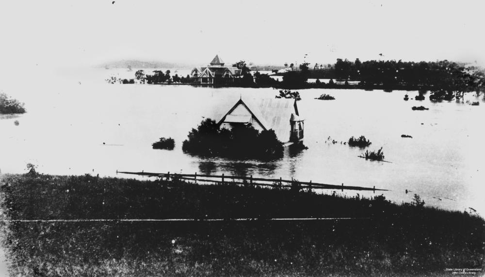 Houses submerged in the floodwaters of the 1893 Brisbane flood, at Toowong. The floodwaters come half way up the house in the foreground. Only the tops of the tallest trees in its garden can be seen. 'John Oxley Library, State Library of Queensland   Image: 22318'.